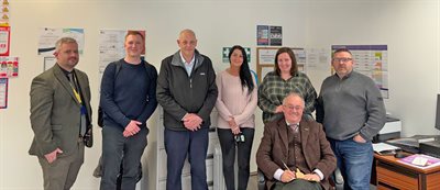 Group of people with Commissioner in a room